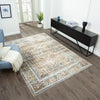 Coral multi-colored transitional rug with intricate floral and geometric patterns on dark wood floor.
