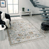 Multi-colored transitional rug with intricate floral and geometric patterns in soft blue, beige, and gray tones on light.