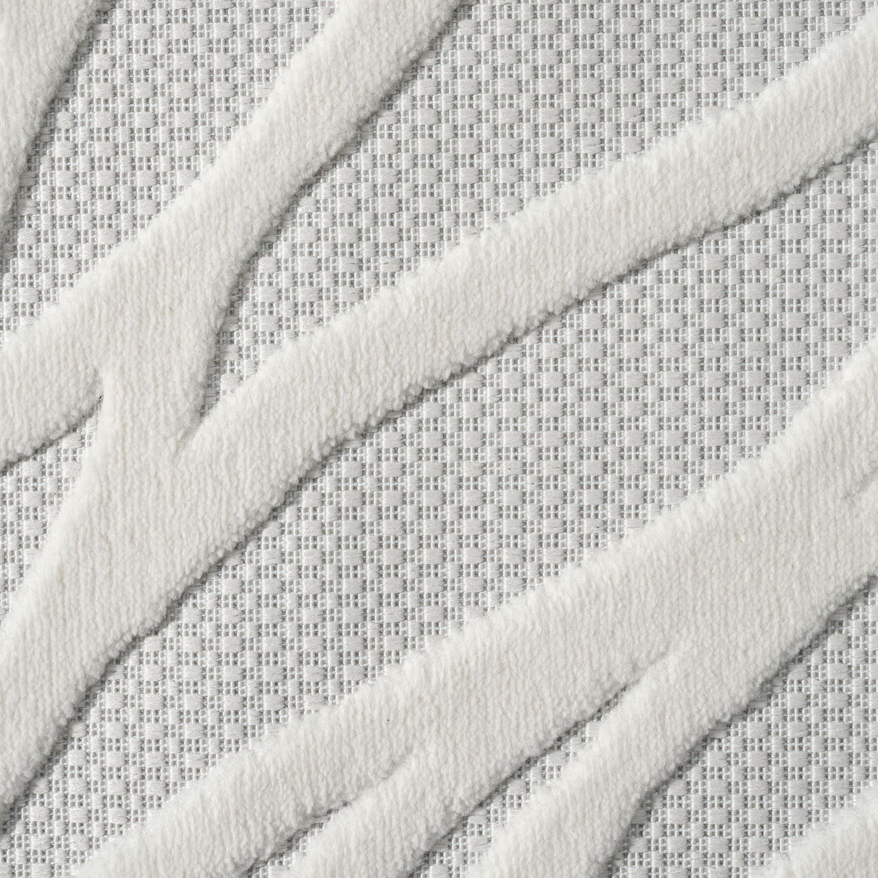 Ivory rug with raised geometric zigzag pattern and textured polypropylene pile on a light neutral background.