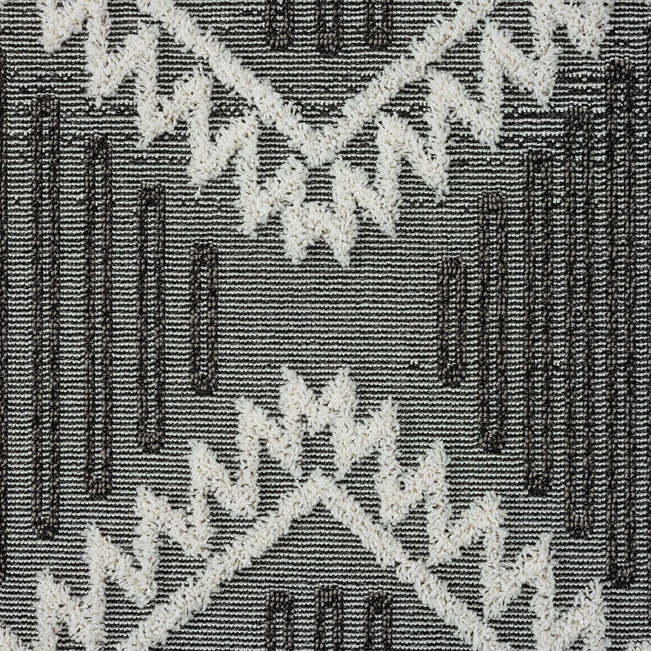 Grey and white geometric patterned runner rug with textured pile and fringed edges.