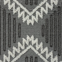 Grey and white geometric patterned runner rug with textured pile and fringed edges.