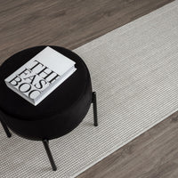 Grey flatweave runner rug with subtle geometric pattern on wood floor.