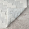 Cream runner rug with textured geometric block patterns and a soft polypropylene pile.
