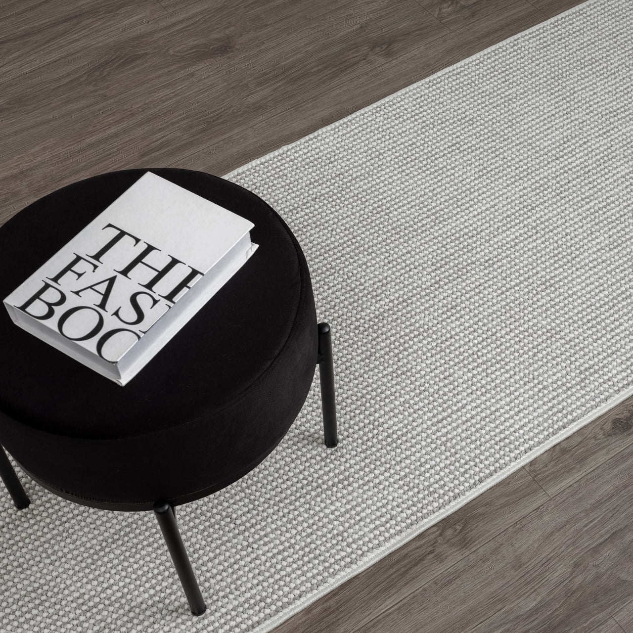 Silver grey flatweave runner rug with subtle textured geometric pattern on wood floor.