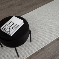 Silver grey flatweave runner rug with subtle textured geometric pattern on wood floor.