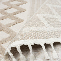 Beige and cream round rug with geometric patterns and tasseled fringes.