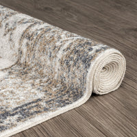 Rolled modern runner rug with neutral earth tones and subtle abstract pattern on wood floor.