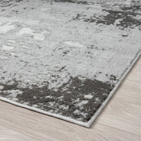 Gray and white textured area rug on a wooden floor