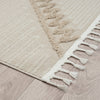 Taupe and beige runner rug with textured geometric pattern and white fringed edges on wood floor.