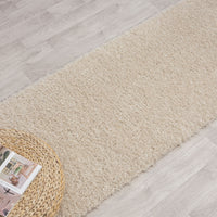 Beige modern shaggy runner rug with soft polyester fibers on light wood floor.