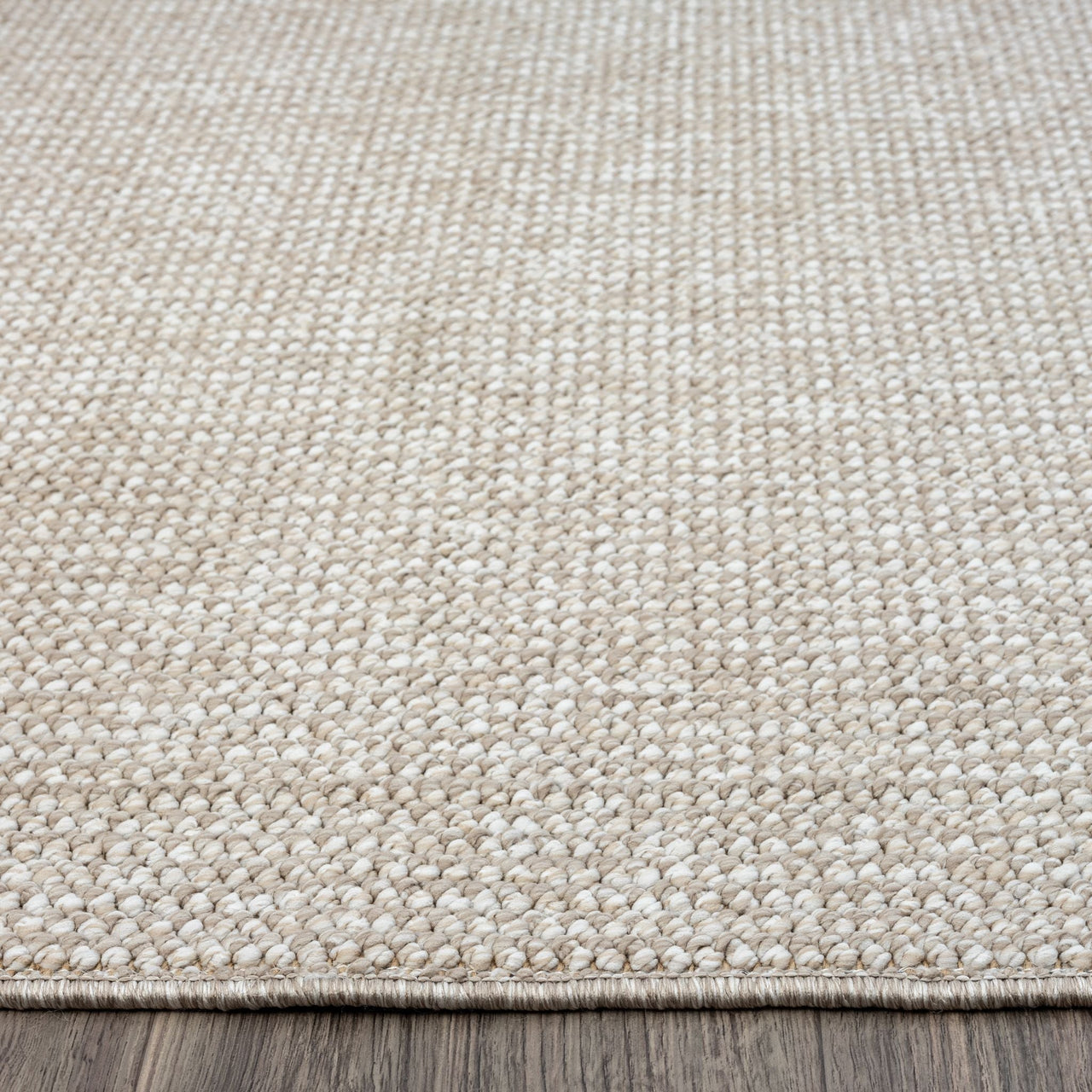 Taupe flatweave rug with subtle textured geometric pattern and tightly woven polyester fibers.