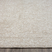 Taupe flatweave rug with subtle textured geometric pattern and tightly woven polyester fibers.