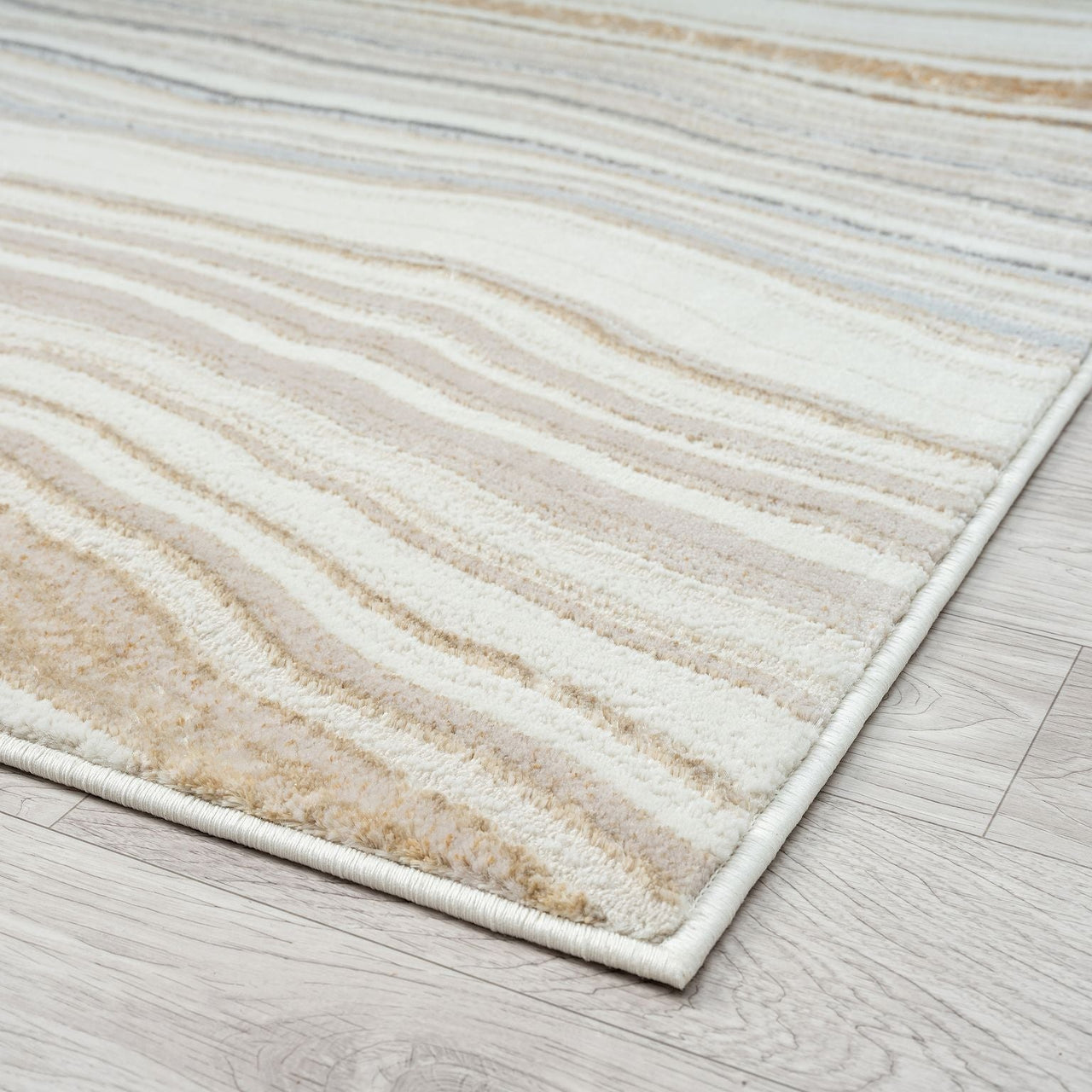 Beige and brown striped rug on a wooden floor