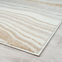 Beige and brown striped rug on a wooden floor