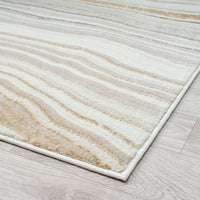 Beige and brown striped rug on a wooden floor