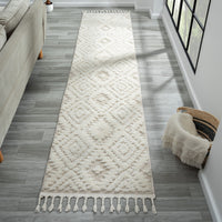 Beige and white runner rug with modern geometric diamond pattern and fringed edges on hardwood floor.