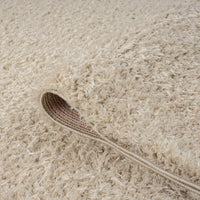 Beige modern shaggy runner rug with thick polyester fibers and textured pile, close-up detail.