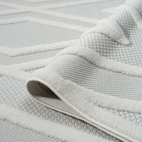 Cream polypropylene rug with raised geometric hexagon pattern and textured pile.