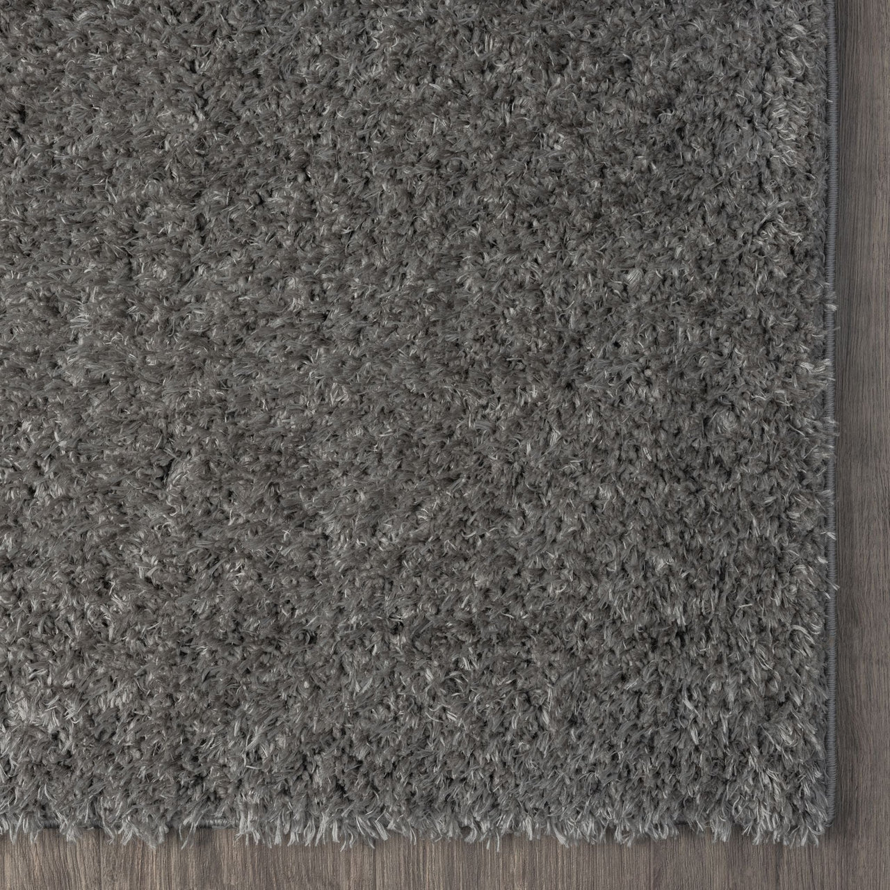Grey and silver modern shaggy runner rug with thick plush polyester fibers and a soft texture.