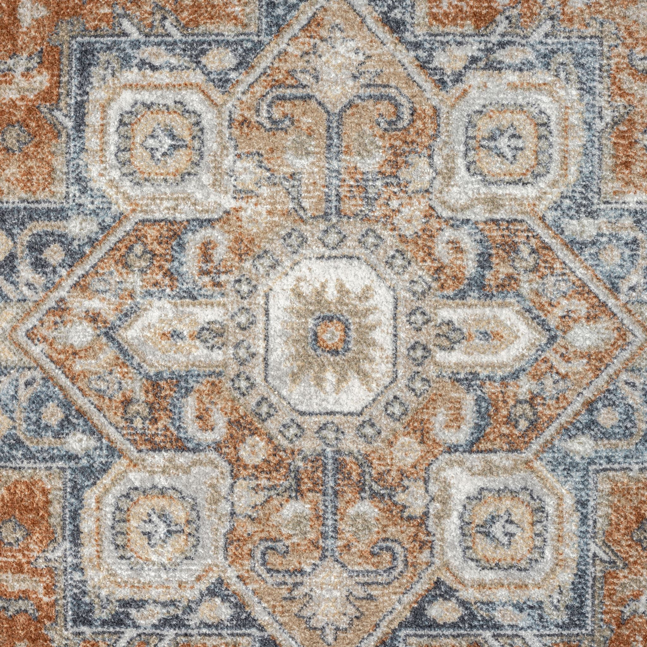 Modern transitional rug with geometric floral pattern in blue, orange, and beige tones.