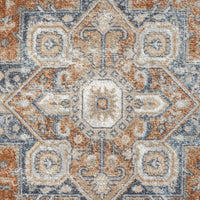 Modern transitional rug with geometric floral pattern in blue, orange, and beige tones.