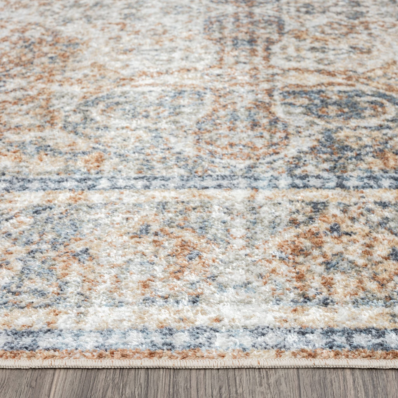 Modern runner rug with coral, beige, and blue abstract pattern and soft texture.