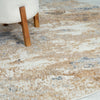 Close-up of a textured area rug with a chair leg in the foreground