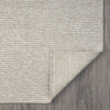 Taupe flatweave runner rug with subtle geometric texture on wood floor.