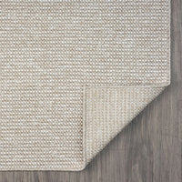 Taupe flatweave runner rug with subtle geometric texture on wood floor.