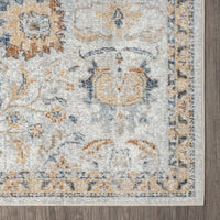 Soft pearl-colored runner rug with intricate floral and geometric patterns in muted blue and gold tones.