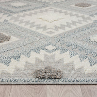 Grey and cream runner rug with textured geometric pattern and fringed edges.