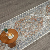 Modern aqua runner rug with intricate geometric patterns in blue, grey, and rust tones on hardwood floor.