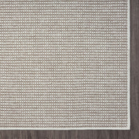 Beige flatweave runner rug with subtle geometric pattern and framed edge border.