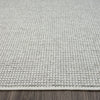 Silver grey flatweave modern rug with subtle textured weave on wooden floor.