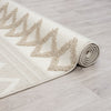 Beige and cream runner rug with textured geometric triangle pattern and fringed edges on light wood floor.