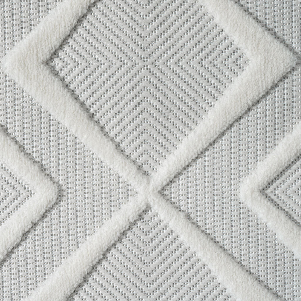 White runner rug with raised geometric diamond patterns and a textured polypropylene pile.