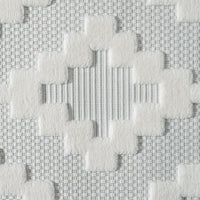 Cream runner rug with textured geometric pattern and subtle striped background.