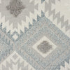 Grey and cream runner rug with modern geometric diamond and zigzag patterns and textured pile.