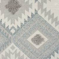 Grey and cream runner rug with modern geometric diamond and zigzag patterns and textured pile.
