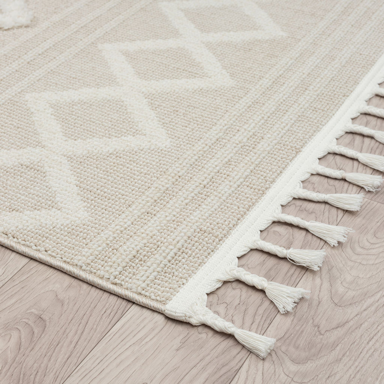 Beige and cream modern runner rug with geometric diamond pattern and fringed edges.