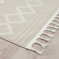 Beige and cream modern runner rug with geometric diamond pattern and fringed edges.