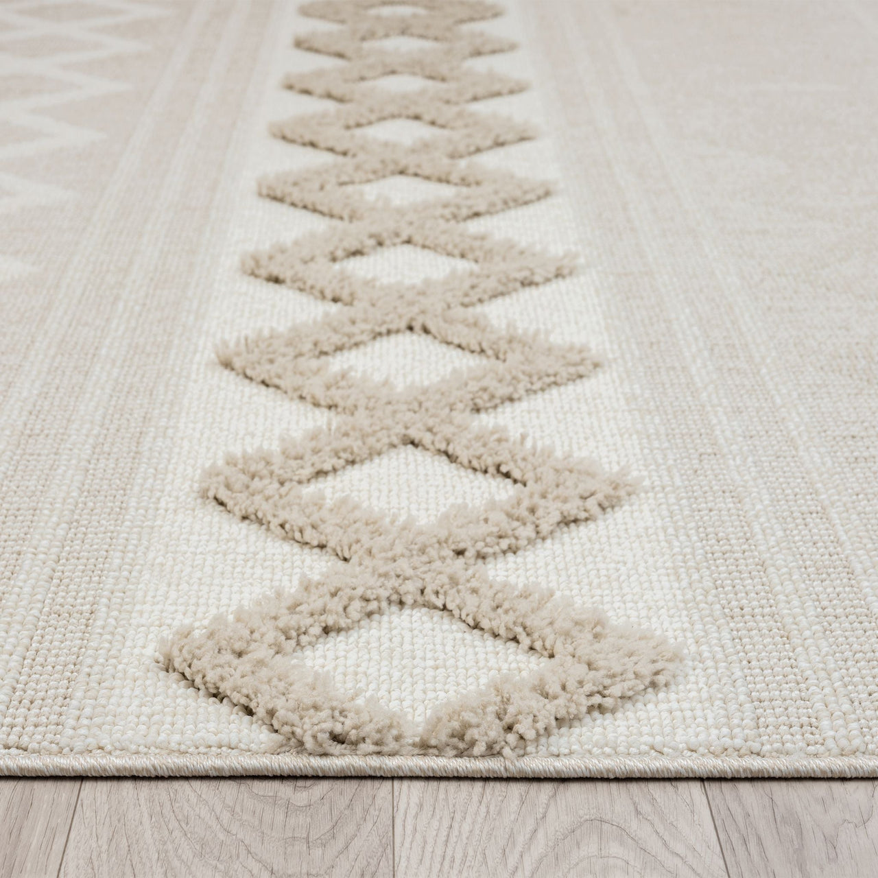 Beige and cream runner rug with raised geometric diamond pattern and subtle textured pile.