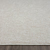 Beige flatweave runner rug with subtle textured geometric pattern and clean edges on wooden floor.