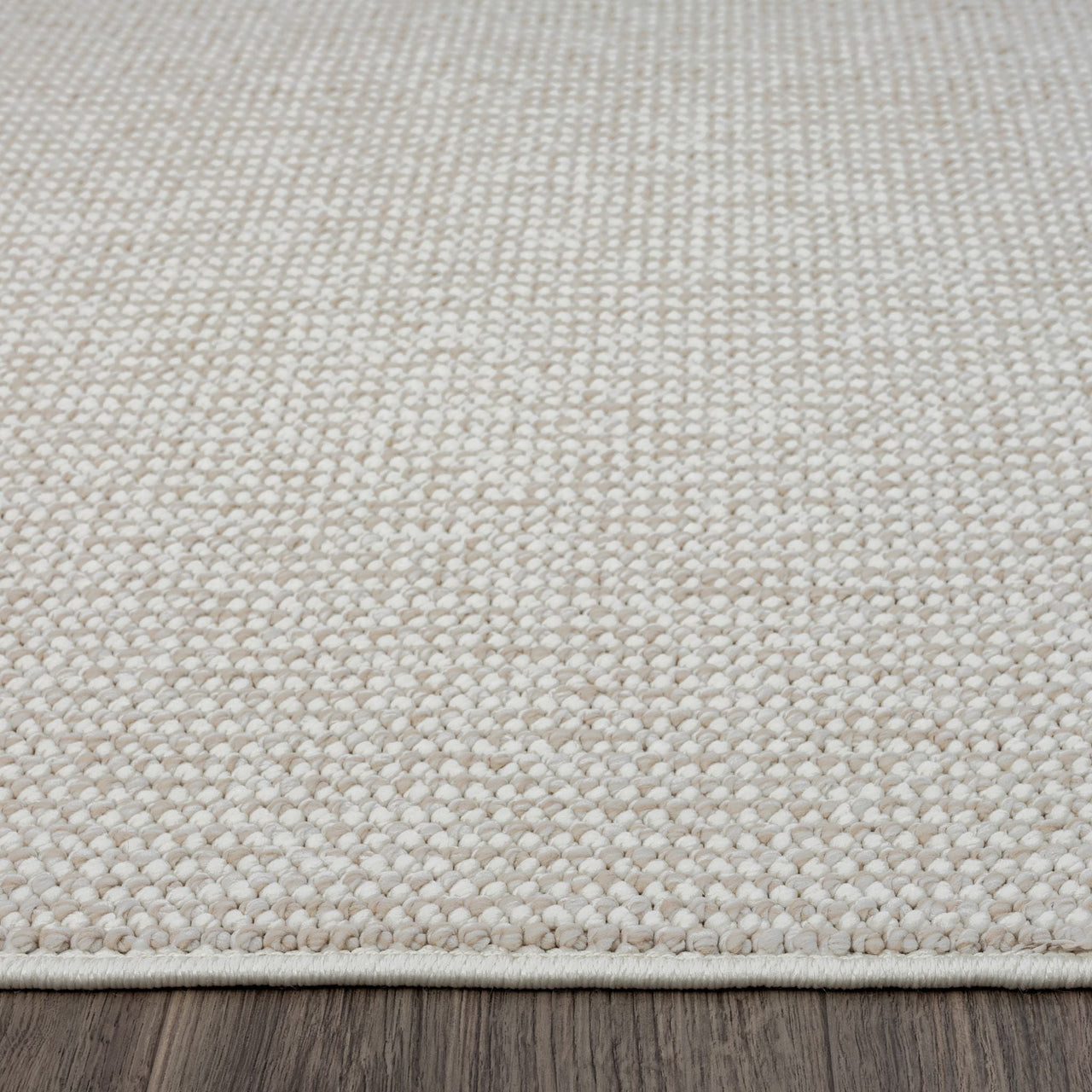 Beige flatweave runner rug with subtle textured geometric pattern and clean edges on wooden floor.