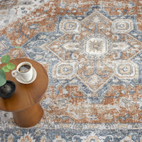 Blue and rust multi-colored transitional rug with intricate medallion design and distressed texture.