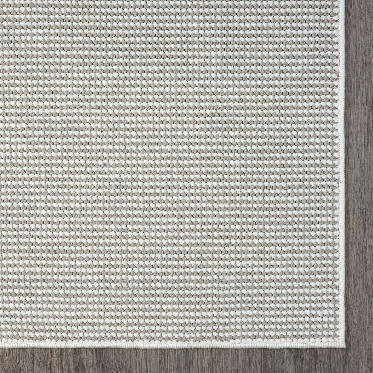 Grey flatweave runner rug with subtle textured geometric pattern and clean white edging.