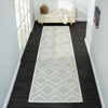 White runner rug with a textured geometric diamond pattern and light neutral tones.
