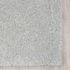Grey modern shaggy runner rug with soft textured polyester fibers on light wood floor.