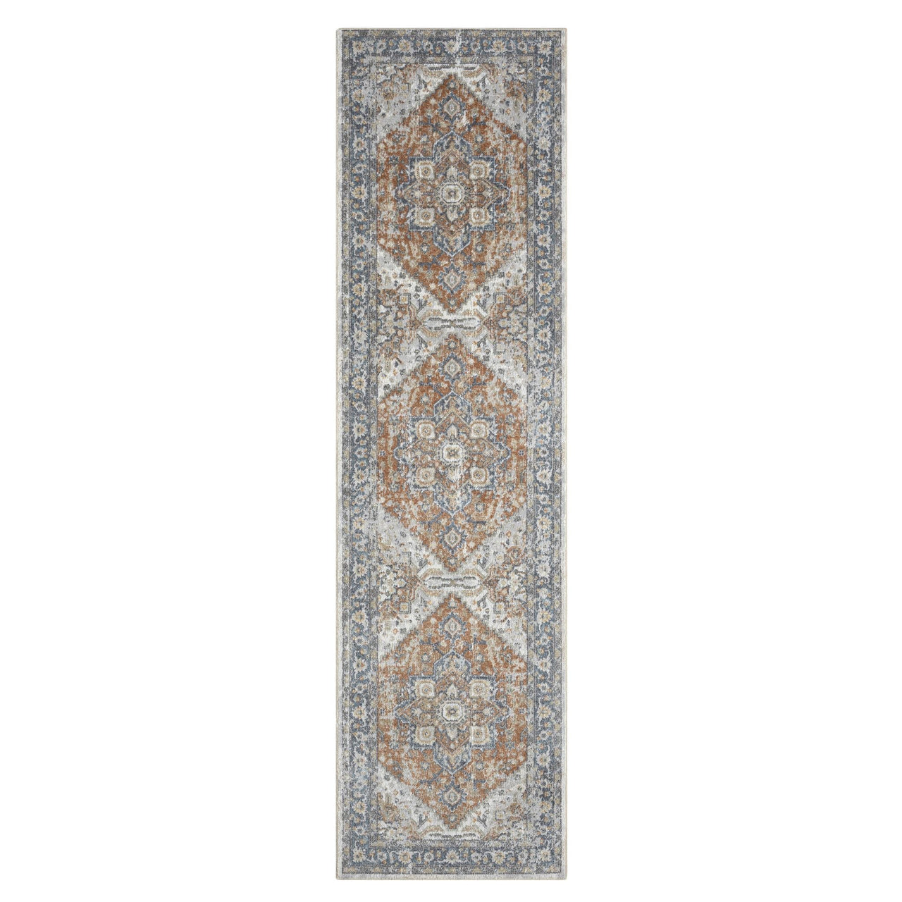Narrow runner rug with intricate geometric and floral medallions in muted blue, beige, and rust tones on a textured.