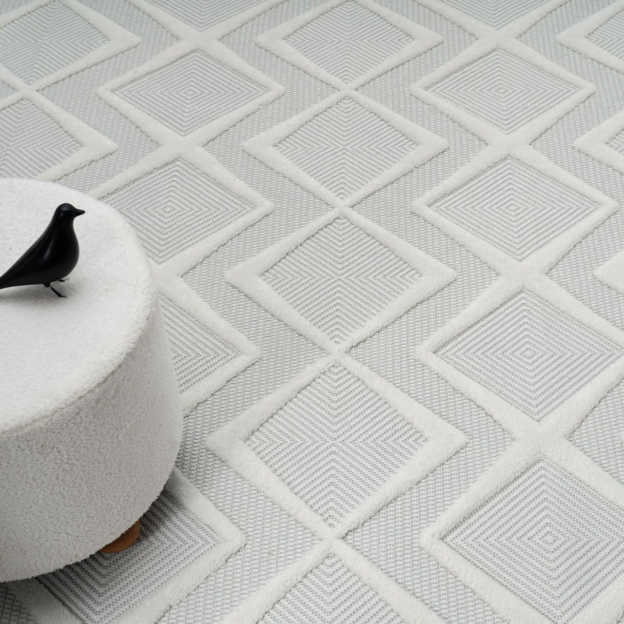 White modern rug with textured geometric diamond pattern and subtle raised lines.